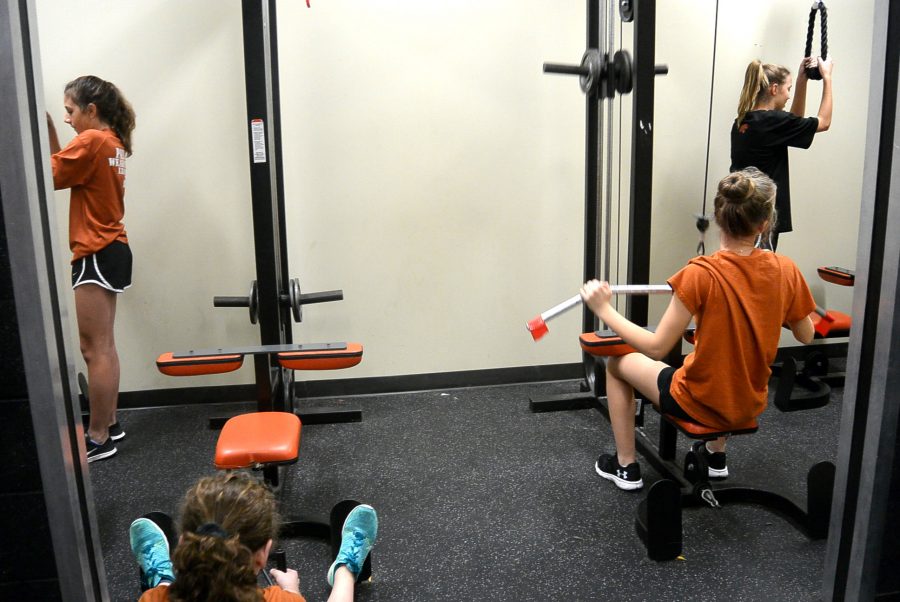 The seventh grade girls Athletics class works out in the newly remodeled weight room.